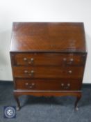 A mahogany bureau on cabriole legs