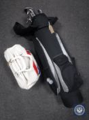 A golf bag containing assorted irons,