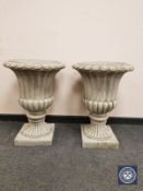 A pair of classical style composition garden urns,