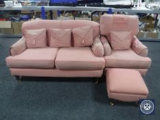 A Victorian style settee and armchair in pink fabric with matching footstool
