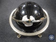 A gemstone globe on stand
