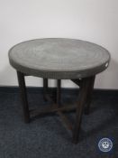 A folding eastern brass topped table