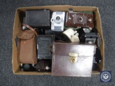 A box containing a collection of vintage folding cameras