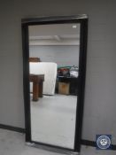 A black framed hall mirror