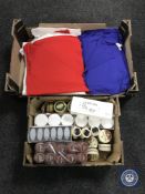 Two boxes containing shoe cleaning products and t-shirts