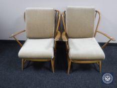 A pair of Ercol armchairs CONDITION REPORT: Webbing is intact.