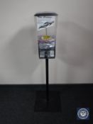 A gum ball dispenser on stand