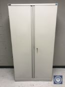 A Triumph double door stationary cupboard with key