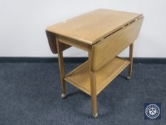 A Priory Oak two tier drop leaf tea trolley