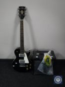 A 20th century Hondo electric guitar together with a guitar amplifier