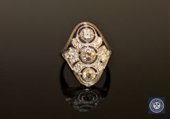 A 14ct white gold diamond ring, with three central brilliant-cut diamonds weighing 0.
