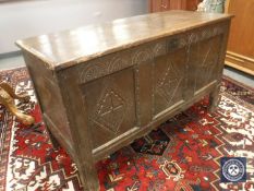 An early 19th century panelled oak coffer,