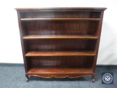 A set of early twentieth century mahogany open bookshelves