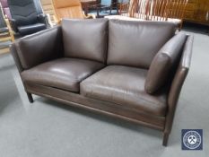 A mid 20th century brown leather two seater settee
