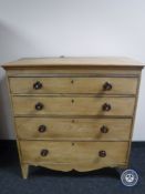 An antique pine four drawer chest