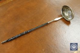 A Georgian silver toddy ladle, inset with a George II six pence dated 1743.