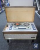 A Carousel reel to reel player with instruction manual and mic.