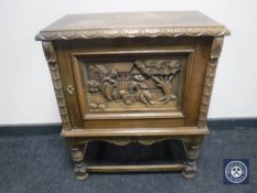 A continental carved oak cupboard