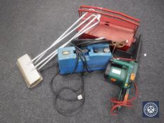 An electric chain saw together with a metal tool box and pump