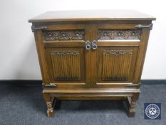 An oak linen fold double door cabinet CONDITION REPORT: 90cm wide by 53cm deep by