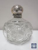 A silver topped cut crystal perfume bottle