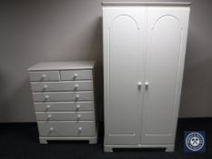 A contemporary white double door wardrobe together with matching six drawer chest