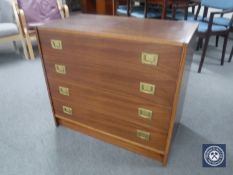 A mid 20th century Danish four drawer chest with brass drop handles