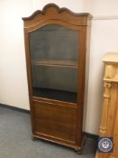 A continental mahogany glazed cabinet on scroll feet,