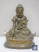 An antique lacquered brass figure of an Eastern deity