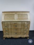 A blond oak serpentine fronted bureau