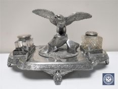 A late Victorian silver plated desk stand mounted with an eagle and two glass inkwells