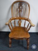 An antique elm kitchen armchair