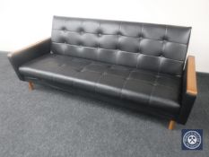 A mid 20th century teak armed bed settee