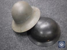 Two WW II helmets.