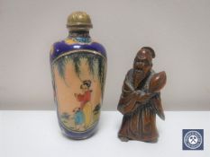 A carved fruitwood netsuke depicting an elderly statesman together with an antique miniature
