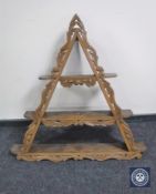A carved oak triangular wall shelf