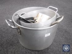 Two large aluminium cooking pans together with further cooking items
