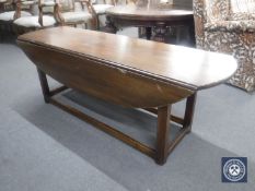 A narrow mahogany drop leaf coffee table