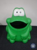 A green plastic recycling bin