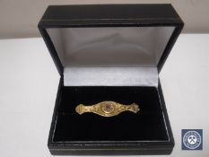 A 9ct gold bar brooch set with split pearls and a small ruby