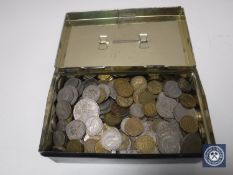 An old money tin containing a quantity of coins, half crowns etc.
