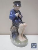A Royal Copenhagen figure of a boy whittling a stick,
