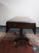 A Victorian mahogany pedestal Sutherland table with lion mask handles