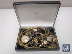 A collection of wristwatches and chains,