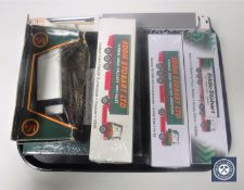 A collection of Eddie Stobart transport vehicles and a porcelain plate