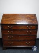 A George III mahogany bureau on bracket feet