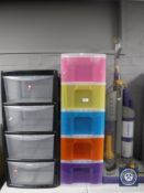 A Dyson DC03 vac together with two plastic storage drawers