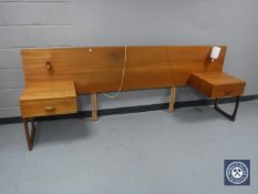 A mid 20th century teak headboard fitted with lamps
