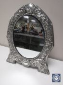 A large silver framed easel mirror