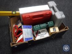 A box containing electrical tools, spirit level, cased drill, electrical testing meter,